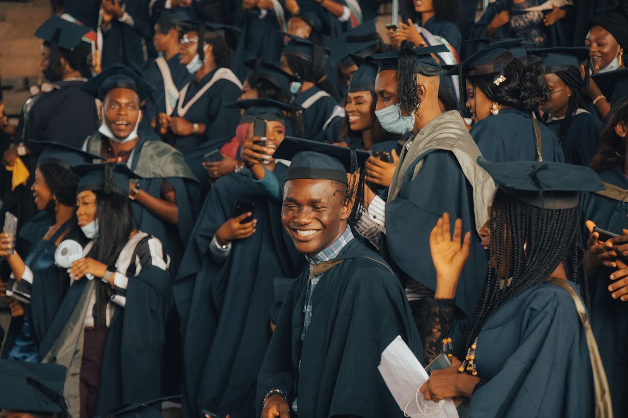 services-04 A group of happy graduates celebrating their achievements at a Nigerian university graduation ceremony.